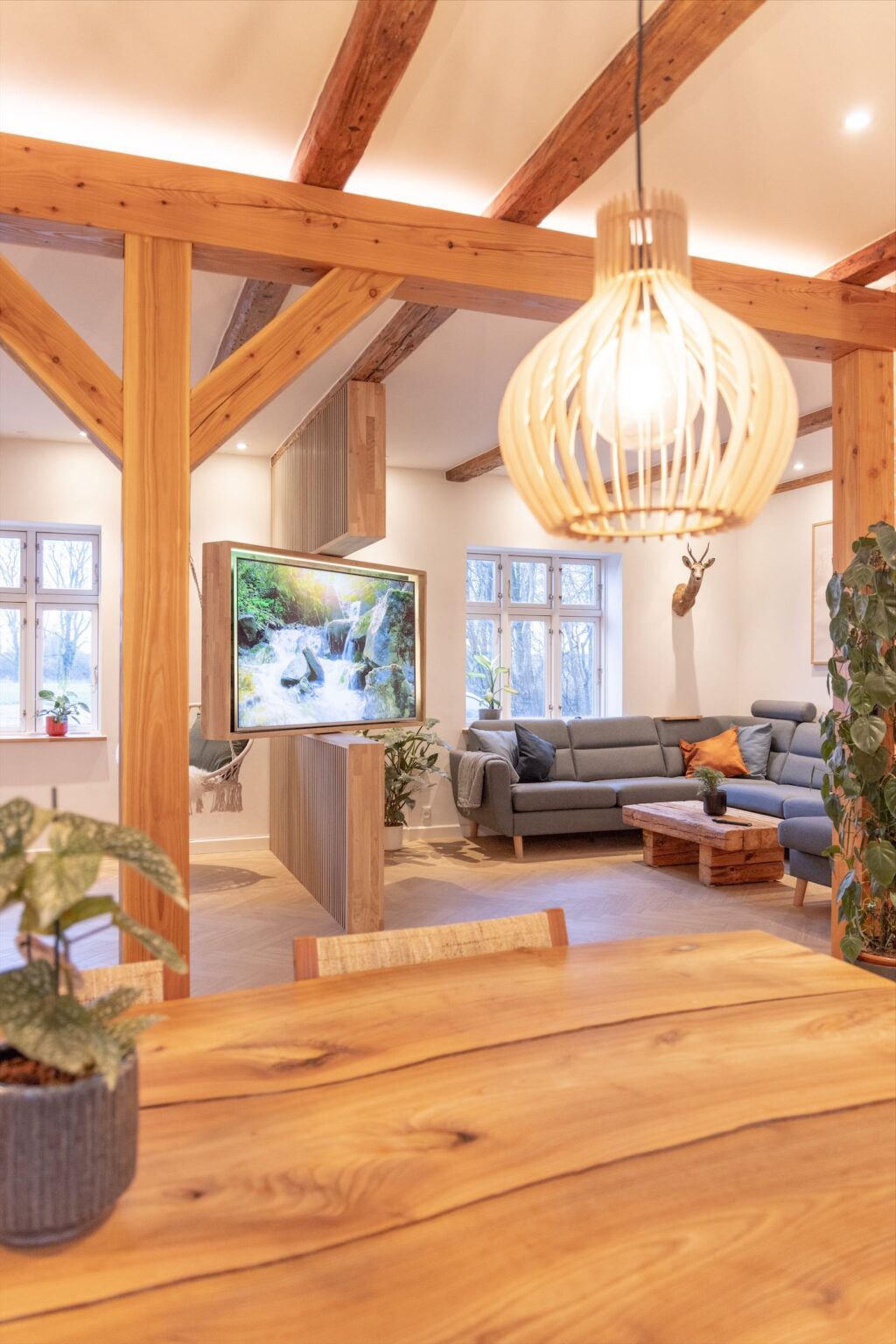 Modern cozy living room with wooden beams and furniture.