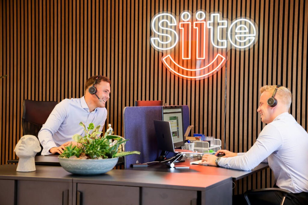 Two men with headsets working in modern office.