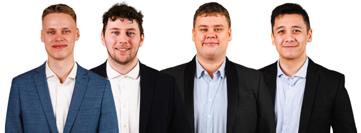 Four men in suits stand together.